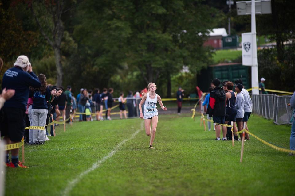 Ursuline's Kyleigh O'Keefe runs down the homestretch en route to winning the girls varsity 2 race during the Brewster Bear Cross-Country Classic Oct. 8, 2023 in Brewster.