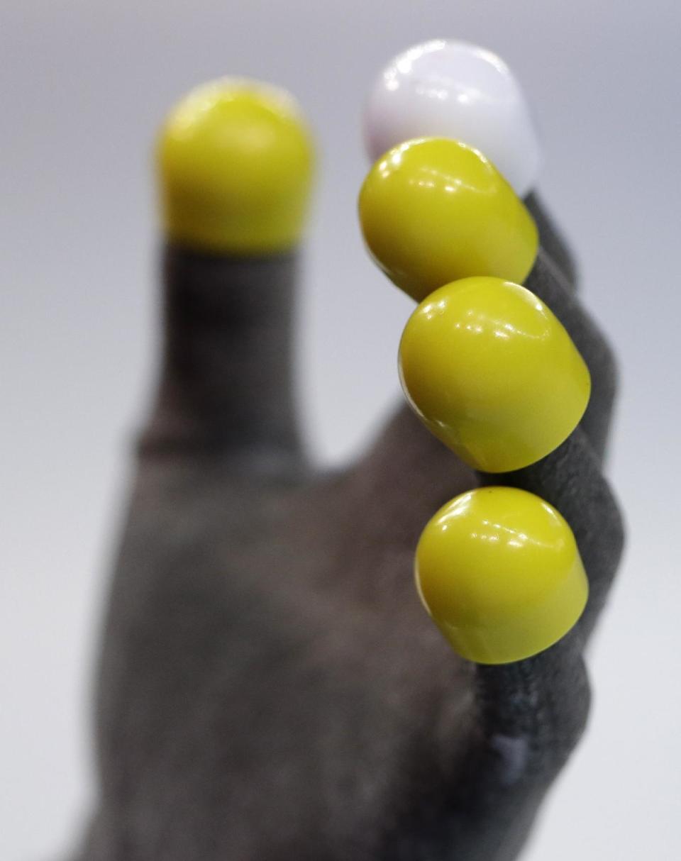 Protective finger tips are seen on the gloves of Dequan Chen of China during the short track speedskating competition at the Iceberg Skating Palace during the 2014 Winter Olympics, Monday, Feb. 10, 2014, in Sochi, Russia. (AP Photo/Darron Cummings)