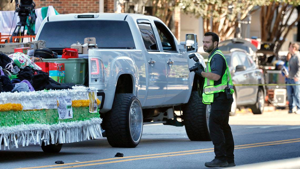 Investigators document the scene where a truck pulling a float went out of control at the Raleigh Christmas Parade killing a young girl, Saturday, Nov. 19, 2022.