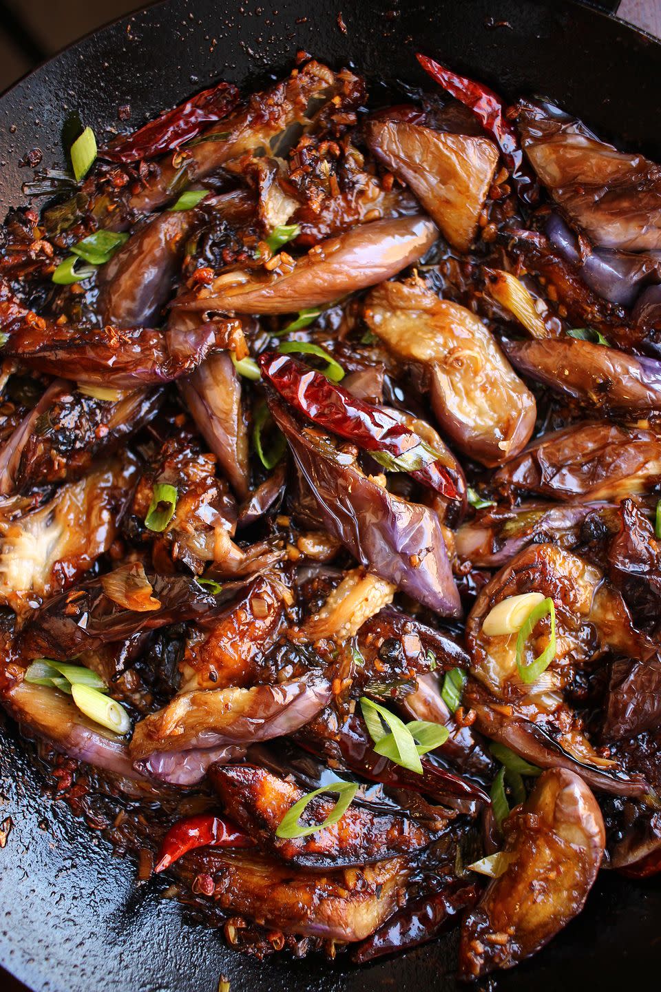 sichuan eggplant with chili peppers, garnished with scallions