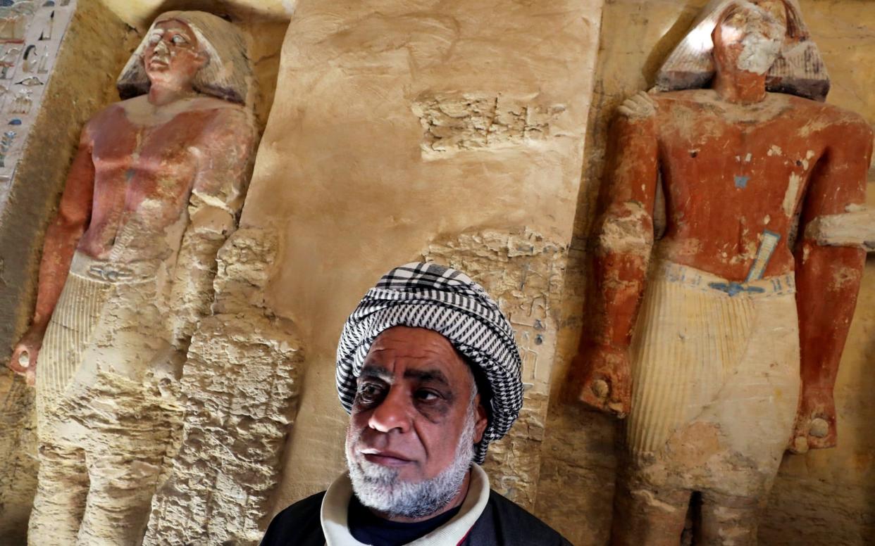 An Egyptian archaeological worker stands inside the newly-discovered tomb of 'Wahtye', which dates from the rule of King Neferirkare Kakai, at the Saqqara area near its necropolis, in Giza - REUTERS