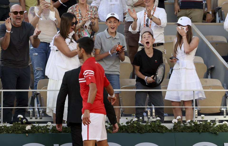 Novak Djokovic of Serbia gives his racket to a lucky and happy fan who cheered for him all match long after winning the Men's Singles final on day 15 of the French Open 2021, Roland-Garros 2021, Grand Slam tennis tournament at Roland Garros stadium on June 13, 2021 in Paris, France. (Photo by John Berry/Getty Images)