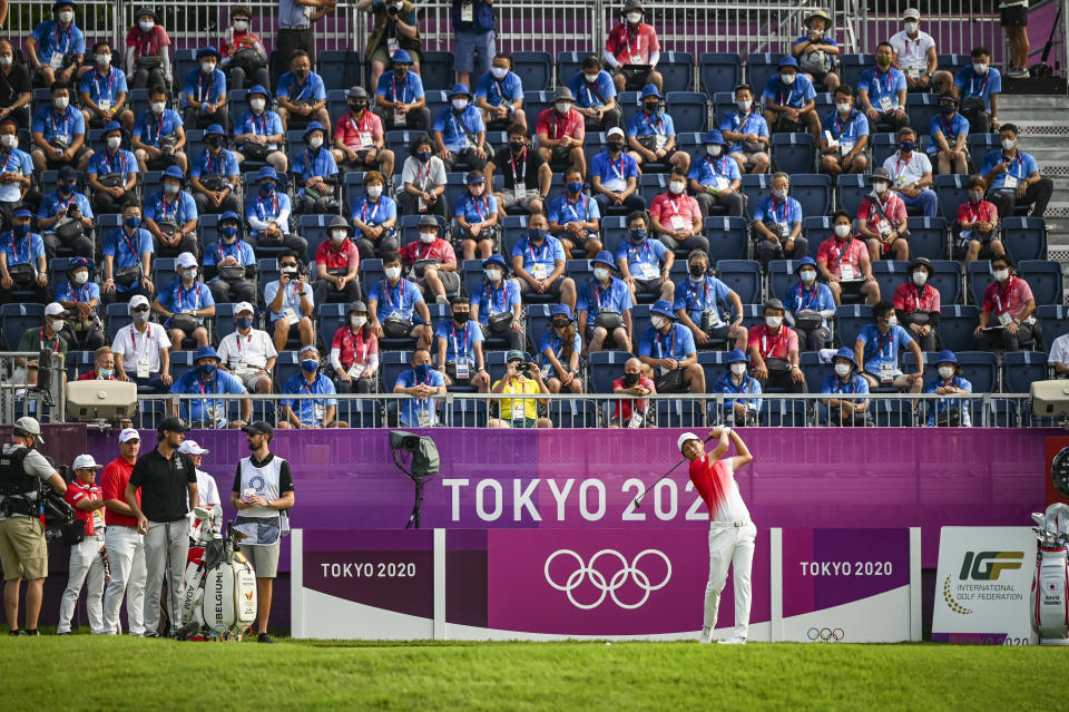 <p>Volunteers watch from the grandstand as Rikuya Hoshino of Team Japan prepares to play his shot on the first tee during the first round of Mens Individual Stroke Play Golf on day six of the Tokyo 2020 Olympic Games on the East Course at Kasumigaseki Country Club on July 29, 2021 in Kawagoe, Saitama, Japan. (Photo by Keyur Khamar/PGA TOUR via Getty Images)</p> 