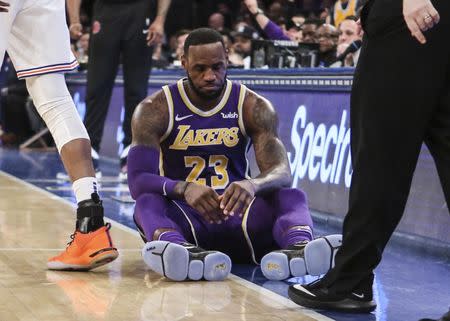 FILE PHOTO: Mar 17, 2019; New York, NY, USA; Los Angeles Lakers forward LeBron James (23) sits on the court after getting fouled in the second quarter against the New York Knicks at Madison Square Garden. Mandatory Credit: Wendell Cruz-USA TODAY Sports