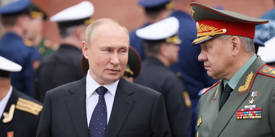 Russian President Vladimir Putin (L) speaks with Russian Defence Minister Sergei Shoigu during a wreath-laying ceremony at the Tomb of the Unknown Soldier in the Alexandrovsky Garden near the Kremlin wall in Moscow on June 22, 2022.