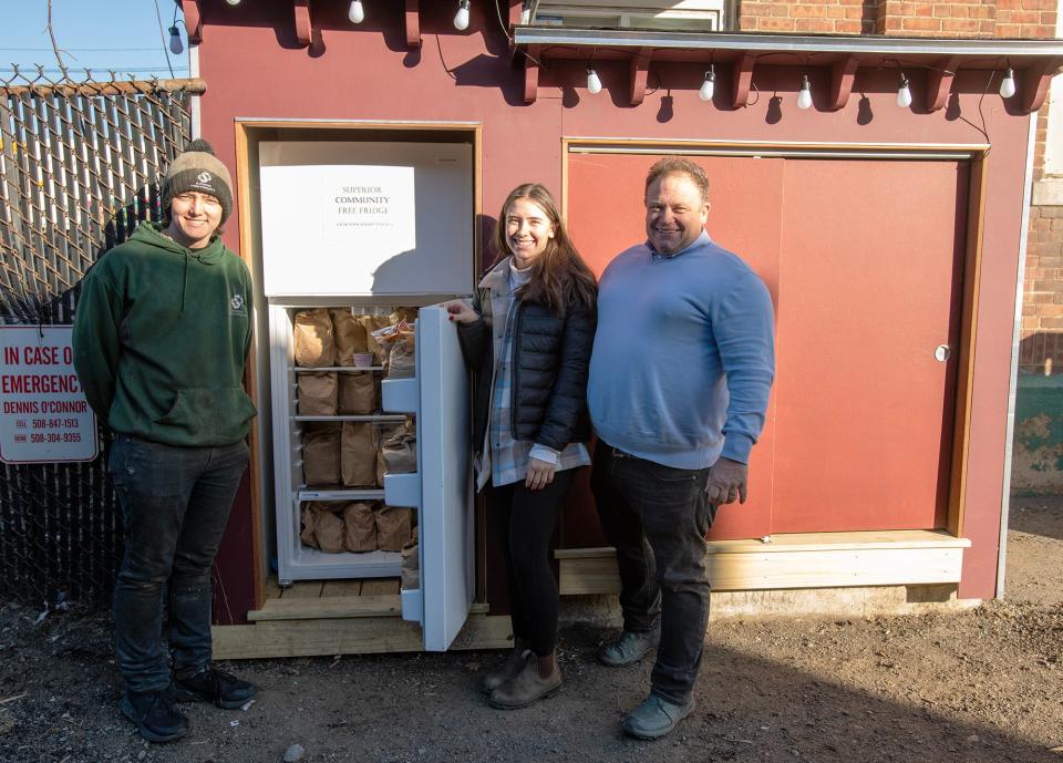 Dennis O’Connor, right, and his children, Terry O’Connor and Maggie O’Connor, keep a community refrigerator filled outside their business on Kansas Street.