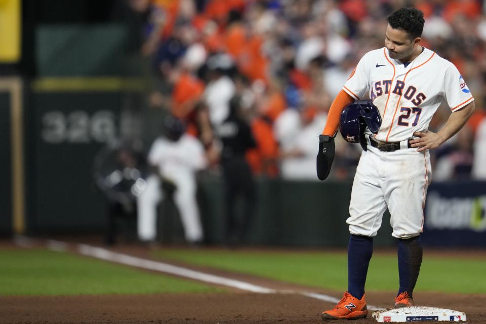 Houston Astros' Jose Altuve reacts after being called out after failing to touch second before returning to first on a fly ball during the eighth inning of Game 1 of the baseball AL Championship Series against the Texas Rangers Sunday, Oct. 15, 2023, in Houston. (AP Photo/Godofredo A. Vasquez)
