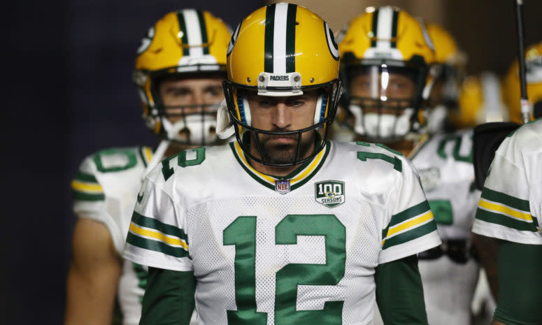 Aaron Rodgers leading his Green Bay Packers team onto the field.