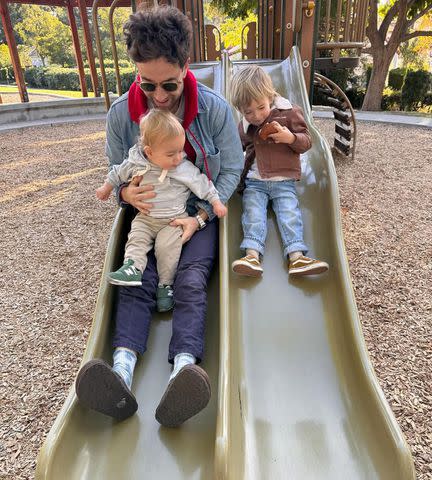 <p>mandy moore/Instagram</p> Taylor Goldsmith with his sons on a slide