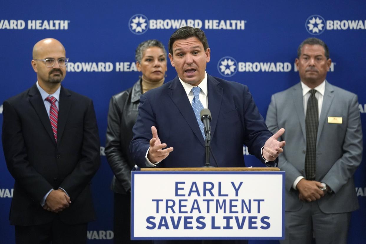 Florida Gov. Ron DeSantis, center, speaks at a news conference alongside Fla. Rep. Tom Fabricio, left, Fla. Agency for Health Care Administration Secretary Simone Marstiller, center rear, and Broward County, Fla., Mayor Michael Udine, right, Monday, Jan. 3, 2022, at Broward Health Medical Center in Fort Lauderdale, Fla.