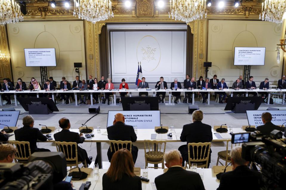 French President Emmanuel Macron, center, speaks during a meeting with officials from Western and Arab nations, the United Nations and nongovernmental organizations at the Elysee Palace, in Paris, Thursday, Nov. 9, 2023. Macron has opened a Gaza aid conference with an appeal for Israel to protect civilians, saying that "all lives have equal worth" and that fighting terrorism "can never be carried out without rules." (Ludovic Marin, Pool via AP)