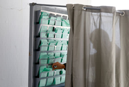 A man takes his ballot before casting his vote for the Andalusian regional elections in Seville, Spain, December 2, 2018. REUTERS/Marcelo del Pozo