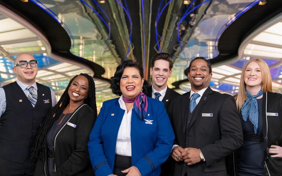 United flight attendants wearing pronoun pins.