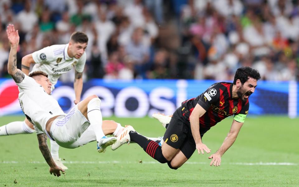 Ilkay Gundogan of Manchester City is tackled by Toni Kroos of Real Madrid during the UEFA Champions League semi-final first leg match between Real Madrid and Manchester City FC at Estadio Santiago Bernabeu - Getty Images/Alex Livesey