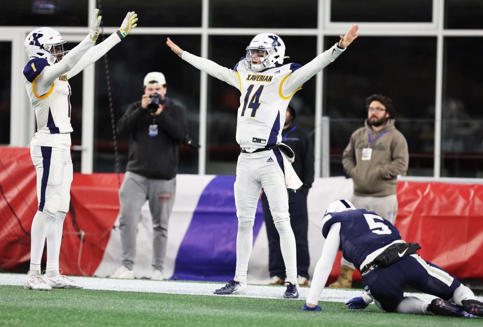 Xaverian defensive back Caleb Brown, left, breaks up the pass to St. John's Prep Marrick Barlow with one second left in the game and celebrates with Henry Hasselbeck during the Division 1 state title game at Gillette Stadium on Wednesday, Nov. 29, 2023.