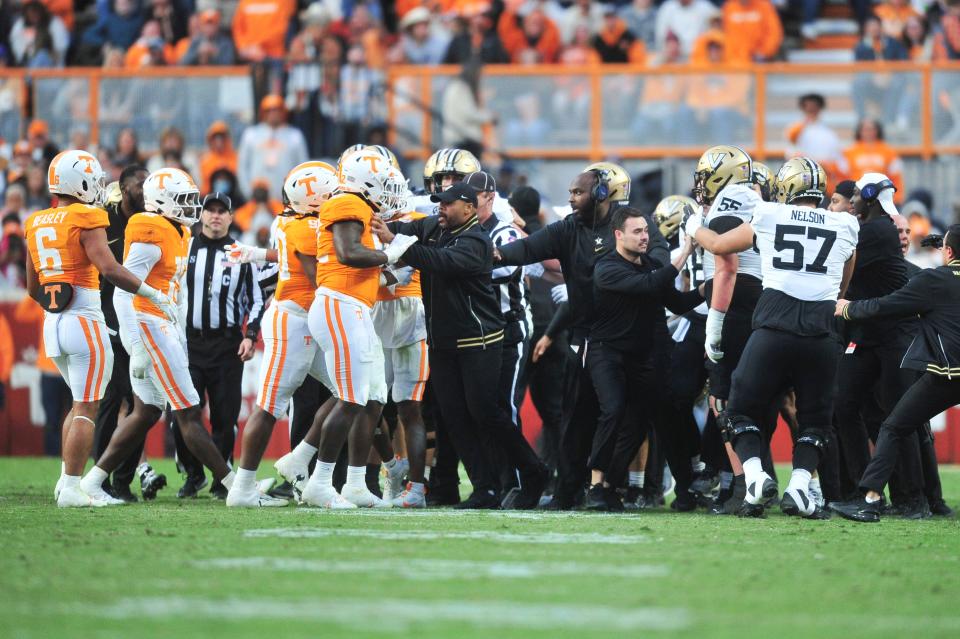 Players leave the benches during a football game between Tennessee and Vanderbilt at Neyland Stadium in Knoxville, Tenn., on Saturday, Nov. 25, 2023.