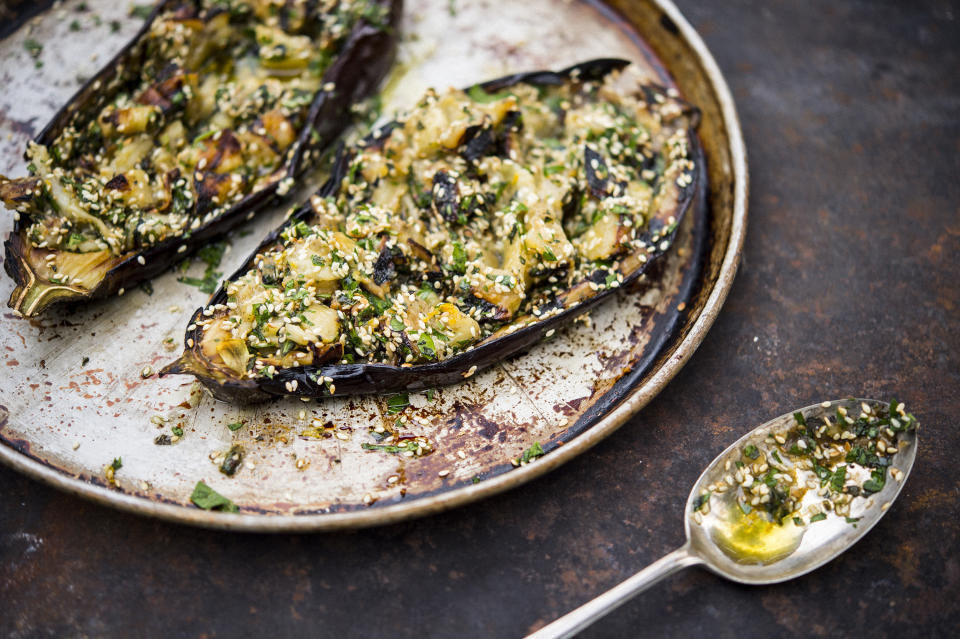 This image released by Milk Street shows a recipe for grilled eggplant with sesame and herbs. (Milk Street via AP)