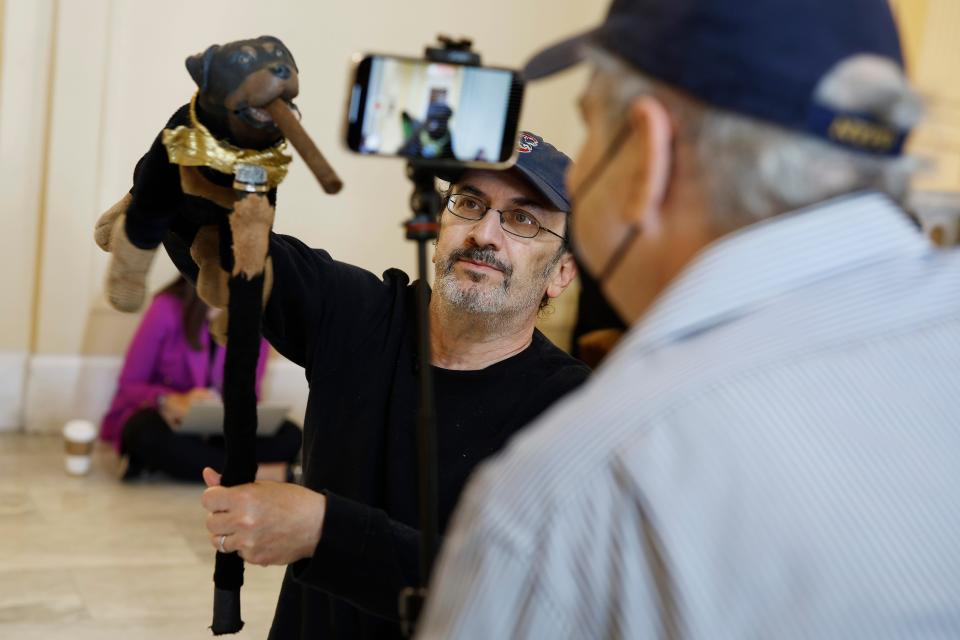 Actor and comedian Robert Smigel performs as Triumph the Insult Comic Dog in the hallways outside the House Select Committee on June 16.