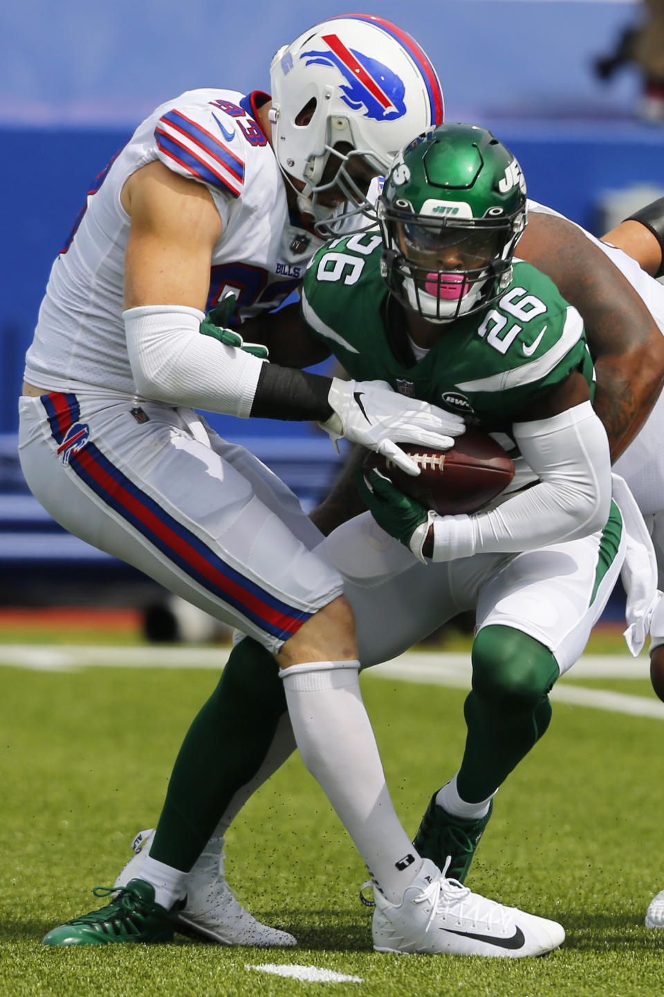 File-This Sept. 13, 2020 file photo shows Buffalo Bills Trent Murphy (93) tackling New York Jets Le'Veon Bell (26) during the first half of an NFL football game in Orchard park, N.Y. The New York Jets have surprisingly released Bell, ending a disappointing tenure after less than two full seasons. The team issued a statement from general manager Joe Douglas on Tuesday, Oct. 13, 2020, in which he says the Jets made the move after having several conversations with Bell and his agent during the last few days and exploring trade options. (AP/ Photo Jeffrey T. Barnes, File)