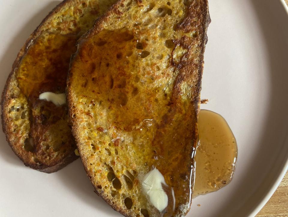 two pieces of french toast on a plate with syrup