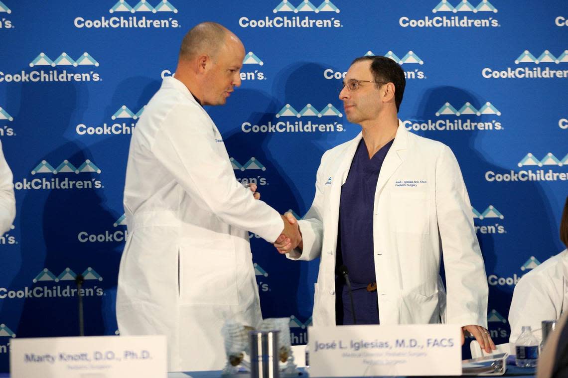 Medical Director of Pediatric Surgery Jose L. Iglesias and pediatric surgeon Marty Knott shake hands after a press conference at Cook Children’s Medical Center in Fort Worth on Wednesday, Jan. 25, 2023. The pair and a large team of medical professionals successfully completed the first separation of conjoined twins, JamieLynn and AmieLynn, for the first time in the hospital’s history.