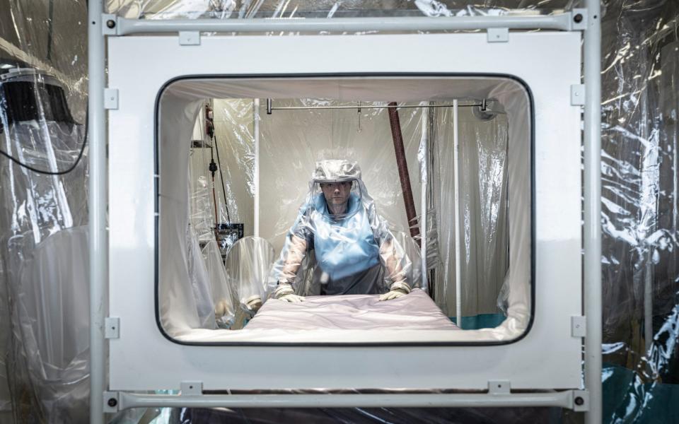 Dr Jake Dunning, Consultant in Infectious Diseases with the isolation tent - Simon Townsley/The Telegraph