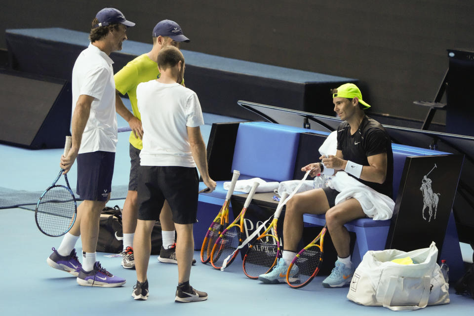 Spain's Rafael Nadal talks with his coaching staff during a practice session on Rod Laver Arena ahead of the Australian Open tennis championship in Melbourne, Australia, Thursday, Jan. 12, 2023. (AP Photo/Mark Baker)