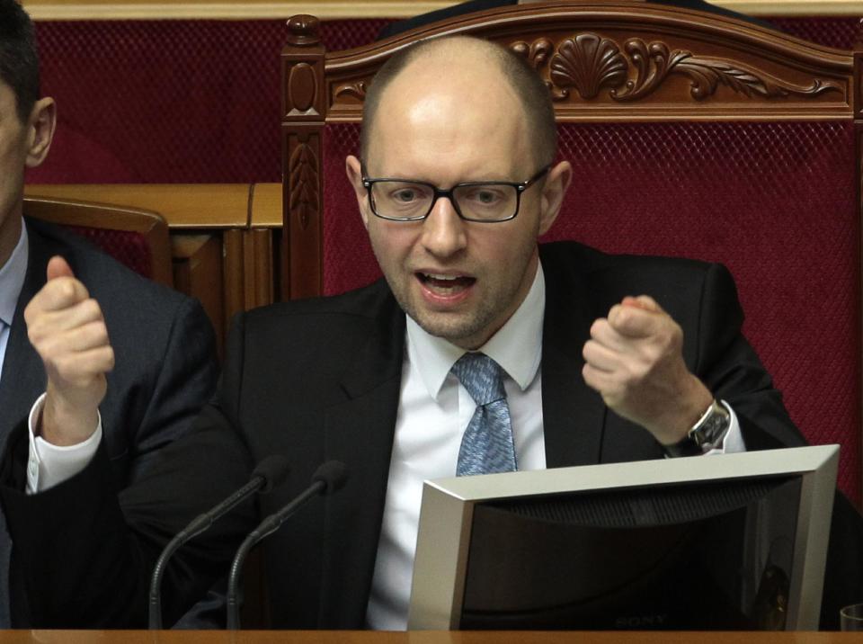 Ukrainian Prime Minister Arseniy Yatsenyuk speaks to lawmakers during a session at the Ukrainian parliament in Kiev, Ukraine, Friday, April 18, 2014. Pro-Russian insurgents in Ukraine's east who have been occupying government buildings in more than 10 cities said Friday they will only leave them if the interim government in Kiev resigns. (AP Photo/Sergei Chuzavkov)