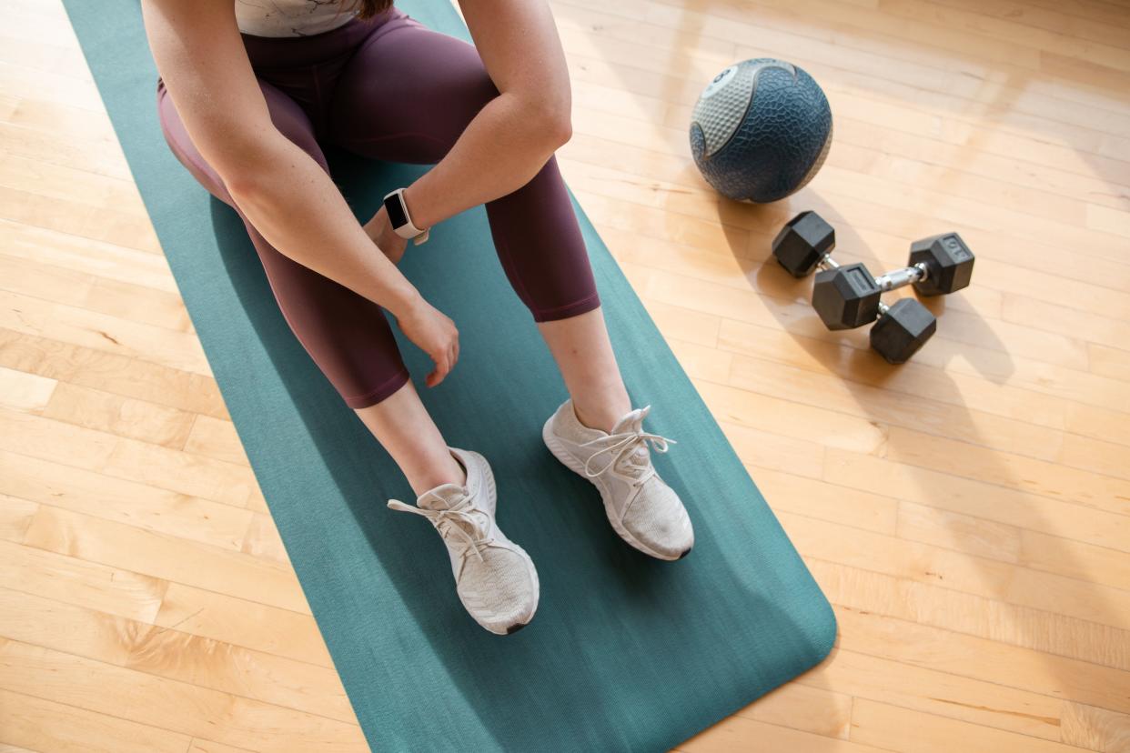 Low Section Of Woman Sitting On Exercise Mat At Home (Photo: Jordan Vanderzalm / EyeEm via Getty Images)