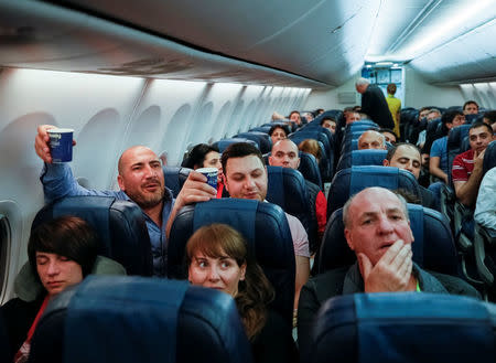 Armenians celebrate during a flight from Kiev, Ukraine, to Yerevan, Armenia, after Armenian Prime Minister Serzh Sarksyan resigned following almost two weeks of mass street protests, April 23, 2018. REUTERS/Gleb Garanich