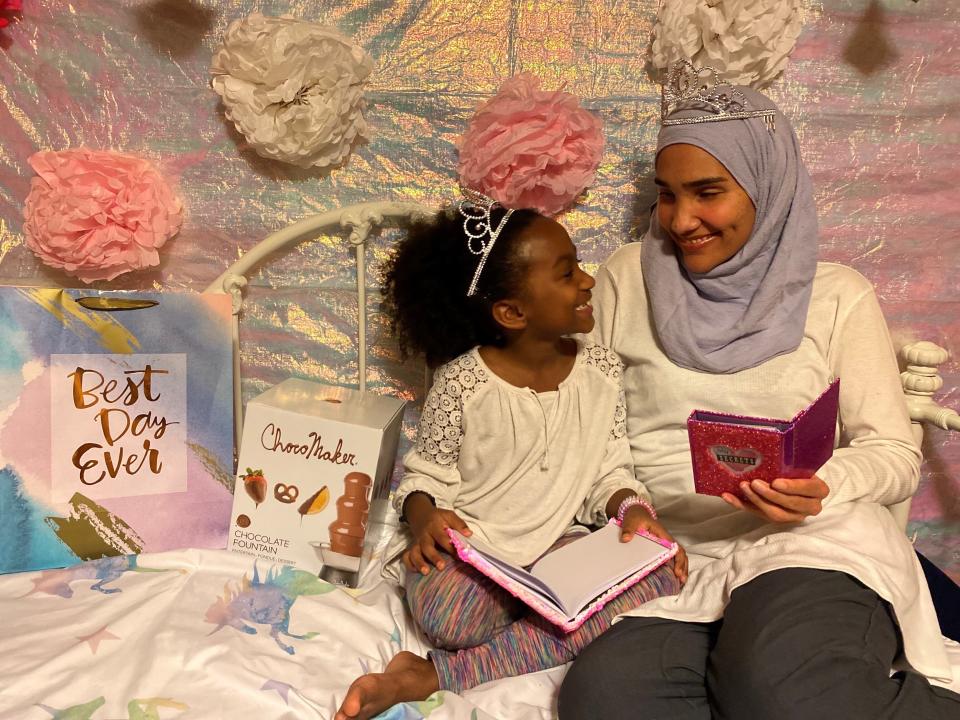 This undated photo shows Melissa Mueller-Douglas and her 7-year-old daughter, Nurah, at their home in Rochester, N.Y. with some of the items they plan to use for a Mother’s Day sleepover. Isolation due to the coronavirus outbreak has led mothers and offspring to find creative ways to celebrate. (Yakub Shabazz via AP)