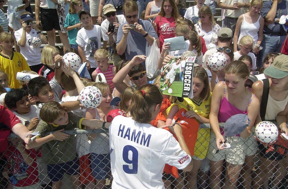 Mia Hamm, shown here signing autographs in 2001, was a national icon in the 1990s and helped bring women's soccer to what it is today. (AP Photo/Jeffrey A. Camarati)