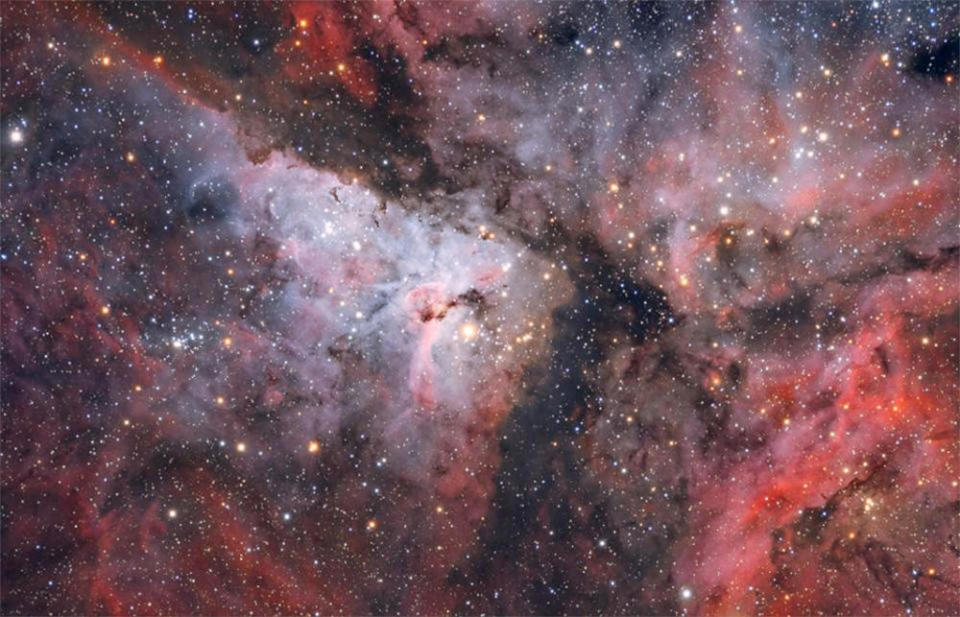 The Carina Nebula, a vast stellar nursery featuring massive young stars in multiple clusters and the debris of supernova blasts, as seen by the Hubble Space Telescope. Webb's infrared view is expected to peer into the dusty clouds to reveal infant suns in the process of being born. / Credit: Maicon Germiniani