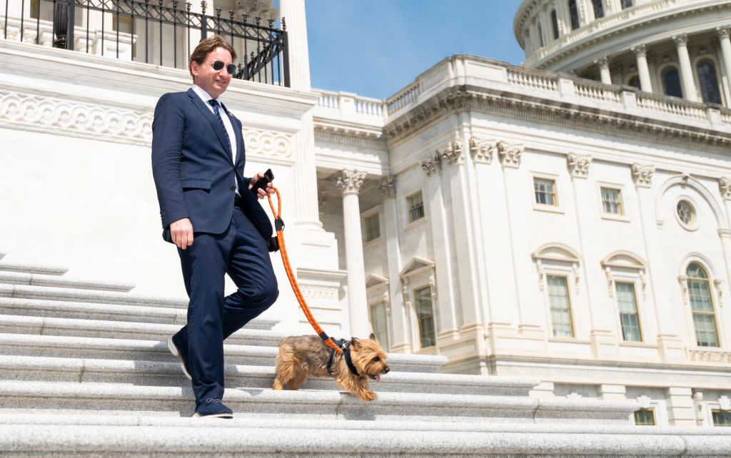  Rep. Dean Phillips, D-Minn., and his dog Henry walk down the House steps of the Capitol. 