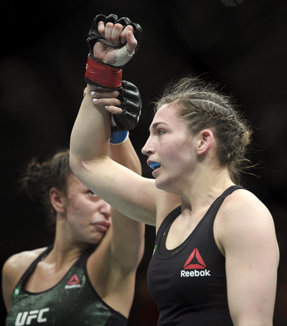 Montana De La Rosa, right, of the U.S., is congratulated by Australia's Nadia Kassem fight during their Women's Flyweight bout at the UFC 234 event in Melbourne, Australia, Sunday, Feb. 10, 2019. (AP Photo/Andy Brownbill)