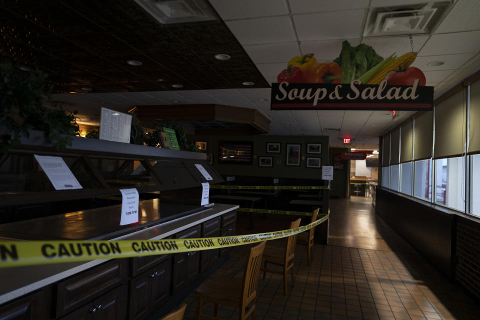 In this April 4, 2020, photo, the Country Pride restaurant is dark and closed with yellow caution tape at the TA Travel Center truck stop in Foristell, Mo. A sit-down hot meal is hard to come by for truckers as the coronavirus outbreak is closing truck stop restaurants and facilities. (AP Photo/Carolyn Kaster)