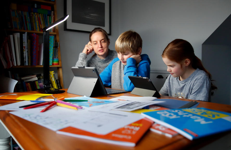 CUCKFIELD, ENGLAND - JANUARY 27: 10 year old Oscar Mumby and 8 year old Harriet Mumby (son and daughter of the photographer) are assisted with their online schoolwork by their mother Jo Mumby as homeschooling continues due to school closures on January 27, 2021 in Cuckfield, United Kingdom. Under current government policy, schools in England wouldn't open before the February half-term break at the earliest, but the prime minister has declined to commit to reopening them before Easter. (Photo by Max Mumby/Indigo/Getty Images)