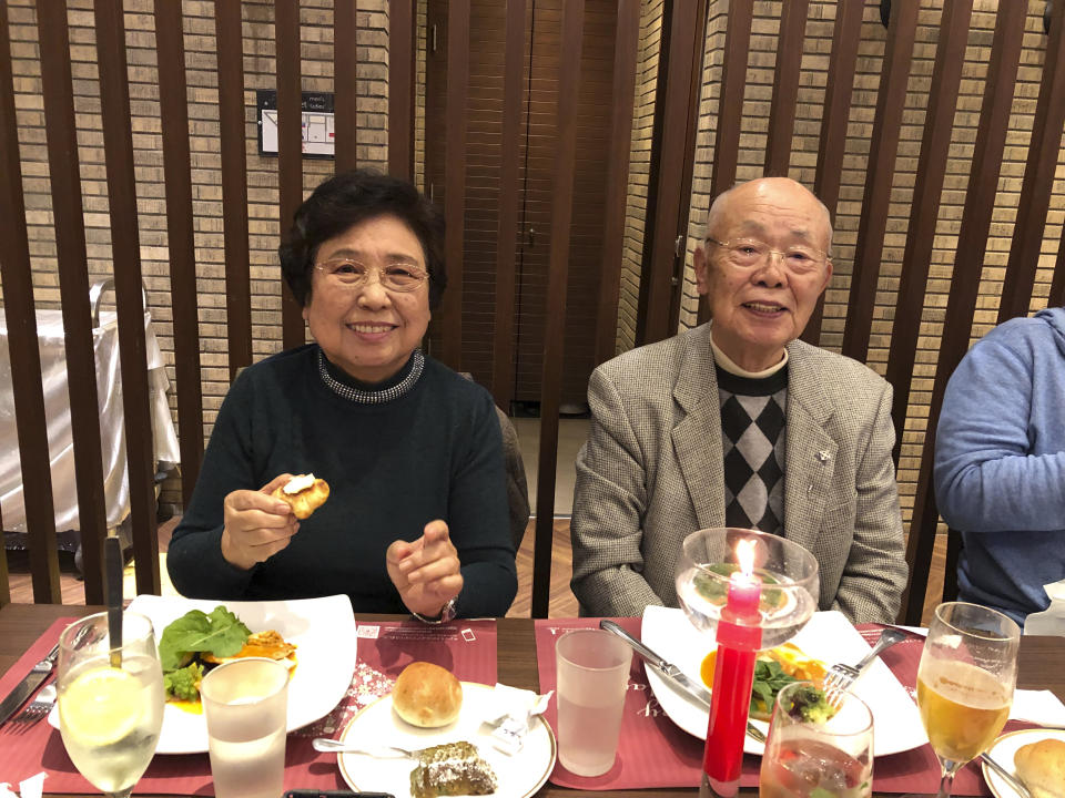 Shizue Akita, left, who died of COVID-19 at an Osaka hospital on May 13, 2021, and her husband Yukihiko Akita smile at Yukihiko's birthday party in Tondabayashi, western Japan, November 2019. As she struggled to breathe, Shizue Akita had to wait more than six hours while paramedics searched for a hospital in Osaka that would treat her worsening COVID-19. When she finally got to one that wasn’t overwhelmed with other patients, doctors diagnosed severe pneumonia and organ failure and sedated her. Akita, 87, was dead two weeks later. (Kazuyuki Akita via AP)