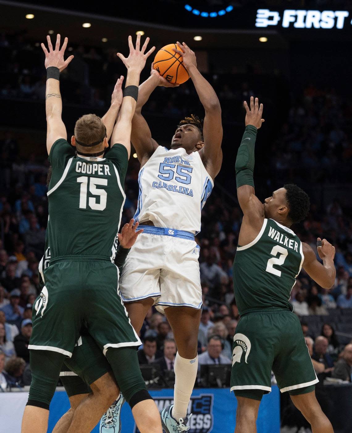 North Carolina’s Harrison Ingram (55) puts up a shot against Michigan State’s Carson Cooper (15) and Tyson Walker (2) during the first half on Saturday, March 23, 2024, during the second round of the NCAA Tournament at Spectrum Center in Charlotte, N.C.