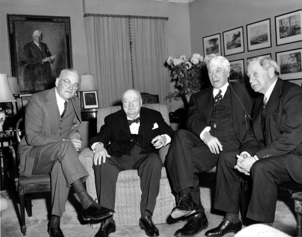 In this Jan. 6, 1953, photo by Associated Press photographer Marty Lederhandler, visiting British Prime Minister Winston Churchill, center, sits with John Foster Dulles, left, secretary of state-designate; Bernard Baruch, second from right, and Winthrop W. Aldrich, ambassador-designate to the Court of St. James, in Baruch’s home in New York.