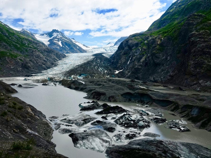 Large mountains and glaciers in a stream of water.