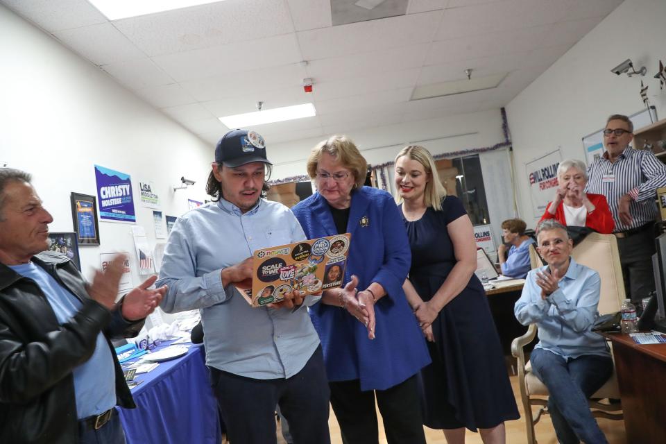 From left, Ivan Aguayo, Lisa Middleton and Christy Holstege view some of the early primary results at the Democratic Headquarters of the Desert in Cathedral City, Calif., March 5, 2024.