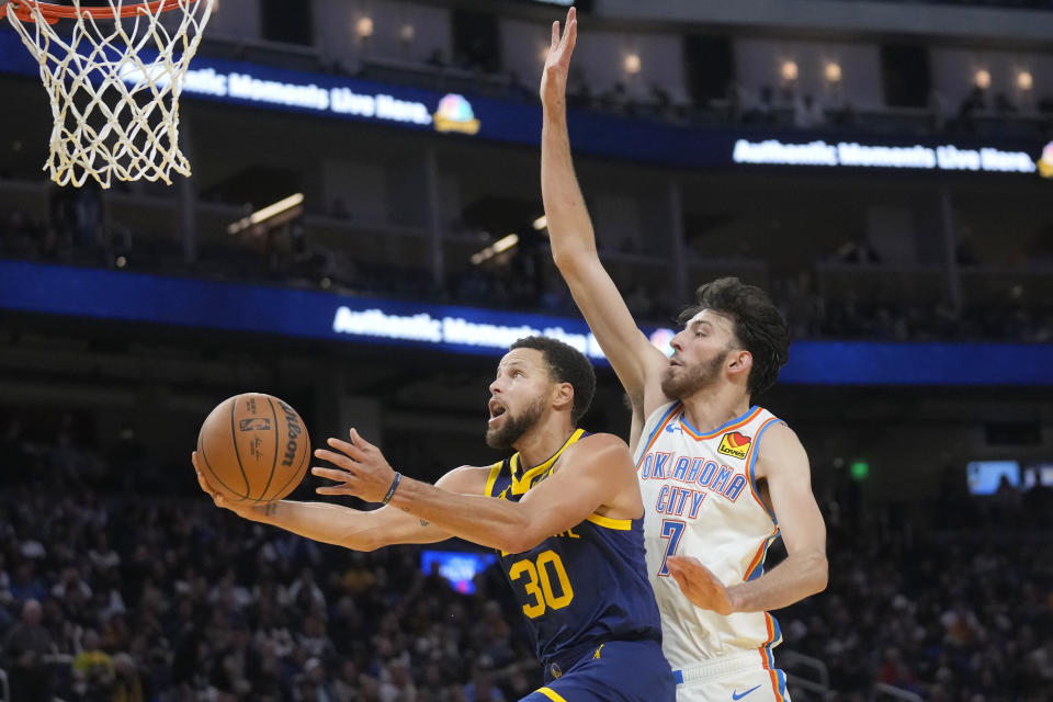 Golden State Warriors guard Stephen Curry (30) shoots against Oklahoma City Thunder forward Chet Holmgren (7) during the second half of an NBA basketball game in San Francisco, Saturday, Nov. 18, 2023. (AP Photo/Jeff Chiu)