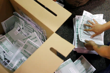 Electoral officials count ballots after tables closed during the seven-question referendum on anti-corruption measures in Bogota, Colombia August 26, 2018. REUTERS/Luisa Gonzalez