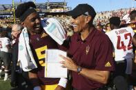 FILE - This Saturday, Oct. 12, 2019, file photo shows Arizona State quarterback Jayden Daniels (5) celebrating with head coach Herm Edwards after an NCAA college football game win over Washington State, in Tempe, Ariz. Arizona State won seven games and played in a bowl game in 2018, exceeding outside expectations in its first season under Edwards, the former NFL player, coach and commentator. The Sun Devils took another step last season, winning eight games and the Sun Bowl. (AP Photo/Ross D. Franklin, File)