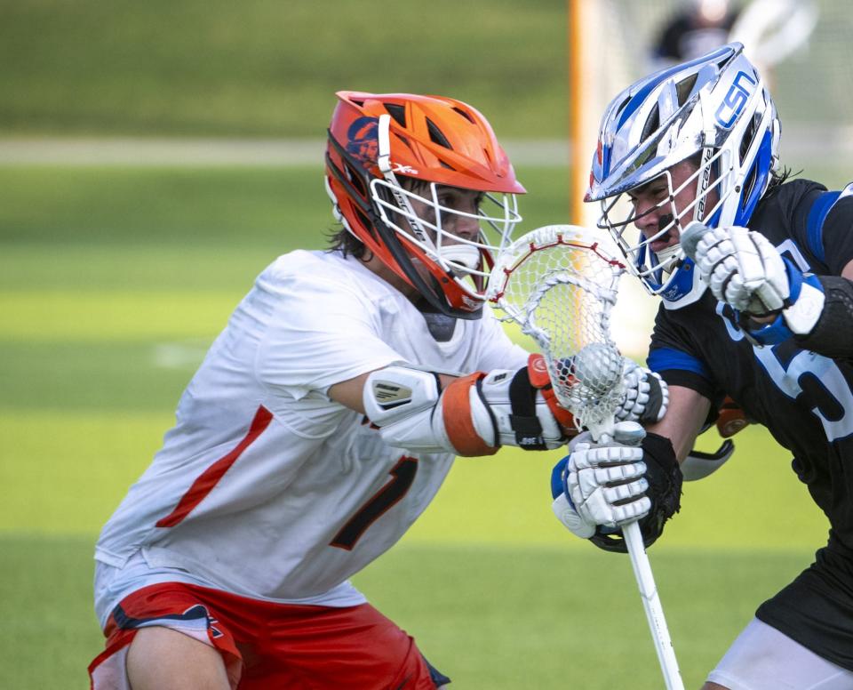 Cal Wyatt of the Community School of Naples pushes through the defense of Jack Kelleher, left, and Ford Cash of The Benjamin School in their Class 1A state championship game in Naples on Saturday evening, May 11, 2024. Photo by Darron R. Silva