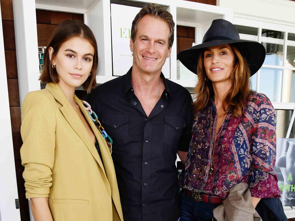 <p>Kevin Mazur/Getty</p> Kaia Gerber, Rande Gerber and Cindy Crawford attend ROCK4EB! at Private Residence on October 06, 2019 in Malibu, California. 