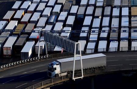 FILE PHOTO: A lorry is driven past dozens of others parked after traveling by ferry between Britain and France at the Port of Dover