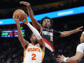 Atlanta Hawks guard Trent Forrest (2) goes up for a shot as Portland Trail Blazers Ashton Hagans (19) defends during the first half of an NBA basketball game Wednesday, March 27, 2024, in Atlanta. (AP Photo/John Bazemore)