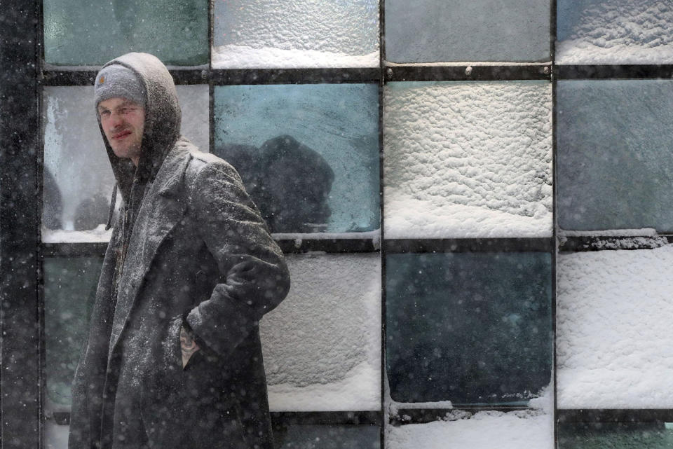 <p>Dan Train waits for a bus outside a crowded bus stop during a snowstorm, Thursday, Feb 9, 2017, in Portland, Maine. The Northeast is experiencing a major winter storm with high winds that could dump a foot or more of snow on parts of New England. (Photo: Robert F. Bukaty/AP) </p>